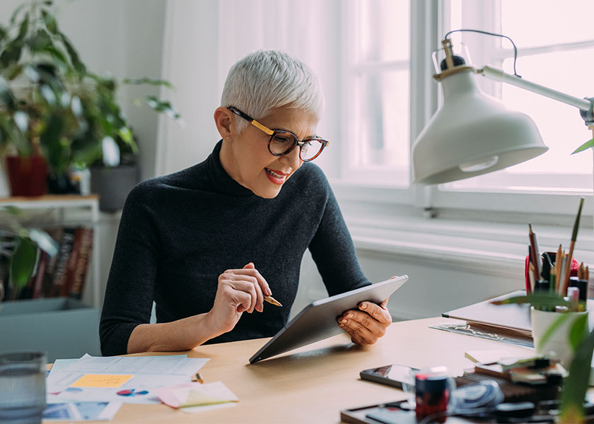 Mature woman working at home office