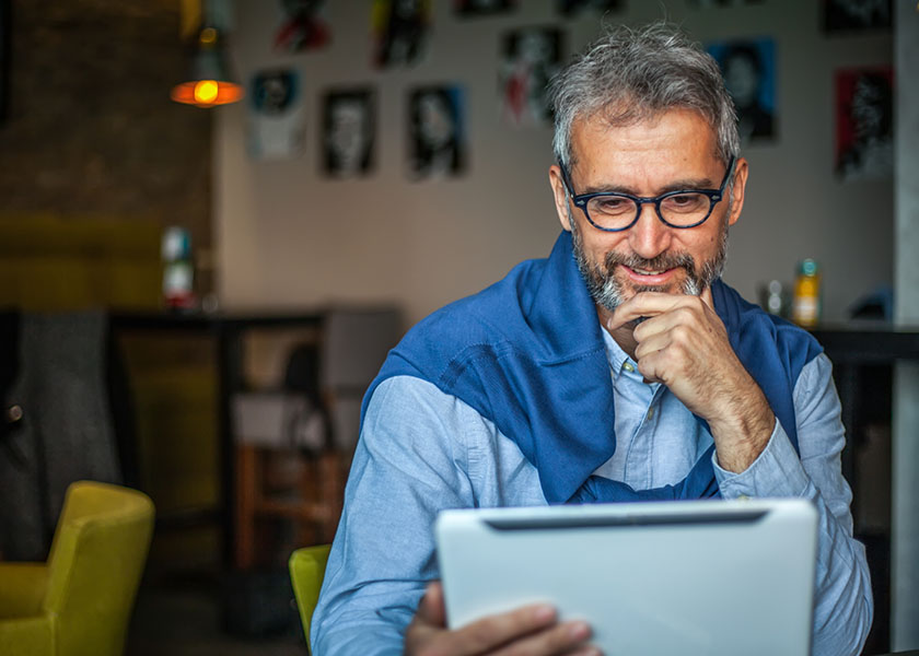 Mature man looking at tablet